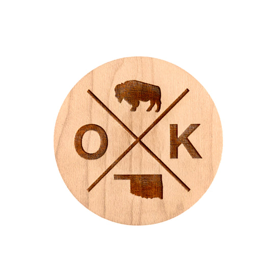 Round wooden magnet made from 1/4” maple, featuring a laser-engraved Oklahoma bison, state outline, and OK symbol