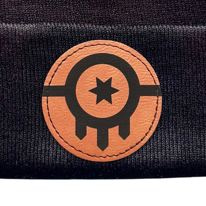 Close-up of the leather patch on a black beanie showcasing the Tulsa Flag design.