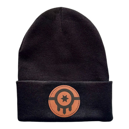 Black knit beanie featuring a leather patch with the Tulsa Flag, showing the full design.