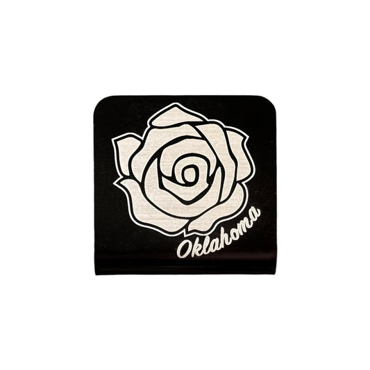 Black metal hat clip featuring an engraved Oklahoma rose design with the word Oklahoma beneath it