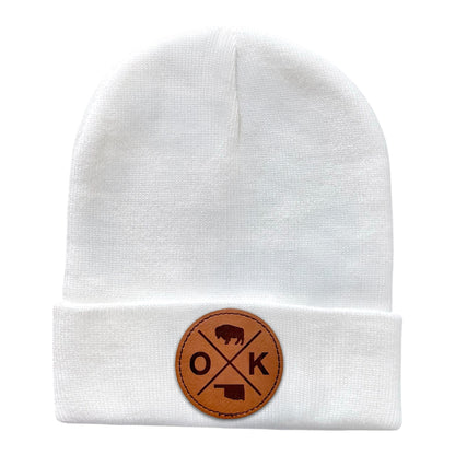 White OK X beanie with a faux leather patch displaying the OK X design featuring a bison and the Oklahoma state outline.