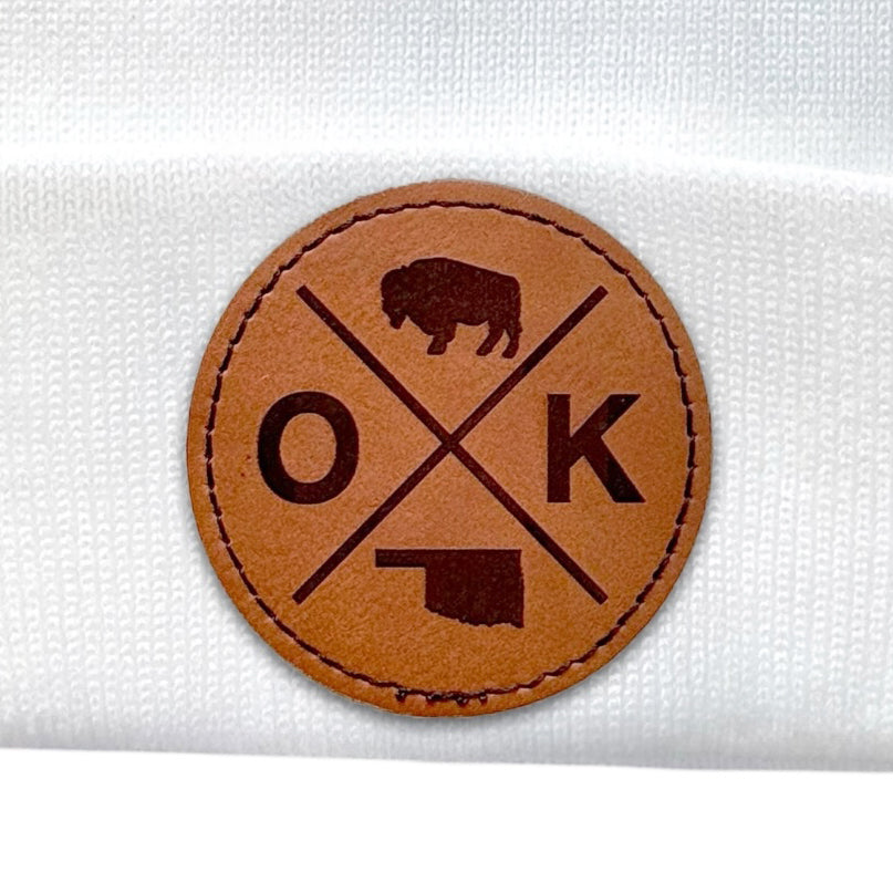 White OK X beanie with the OK X patch clearly displayed on the cuff.